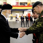 Pipe Major CWO (retd) Jack Coghill and Maj Laird Coghill salute the Commanding Officer before presenting the medal bar of Father and Grandfather Pte John R. Coghill, M.M. to the Regiment